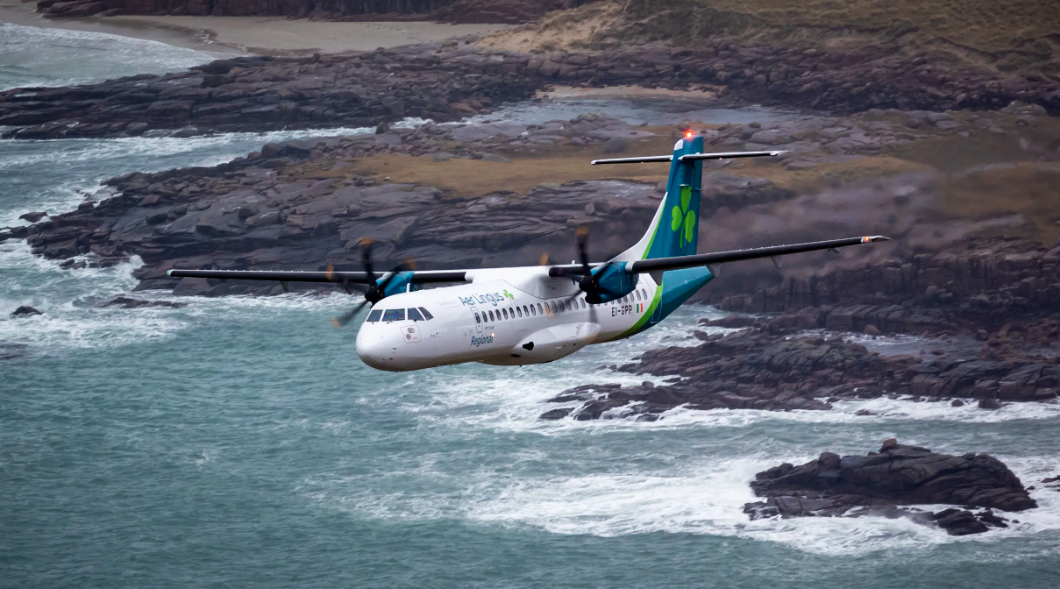 Emerald Airlines aircraft flying over the ocean