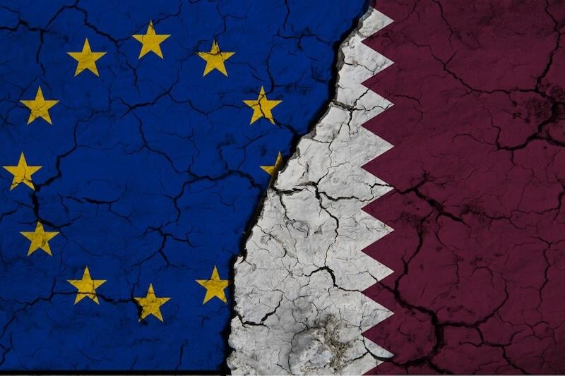 EU and Qatar flags superimposed over cracked earth