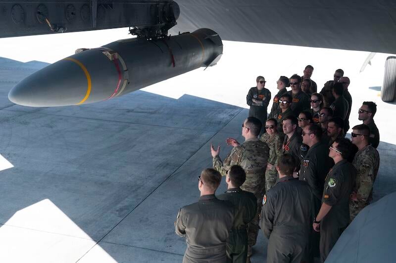 military personnel inspect missile