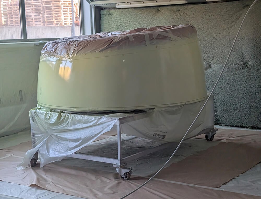 Engine component being painted