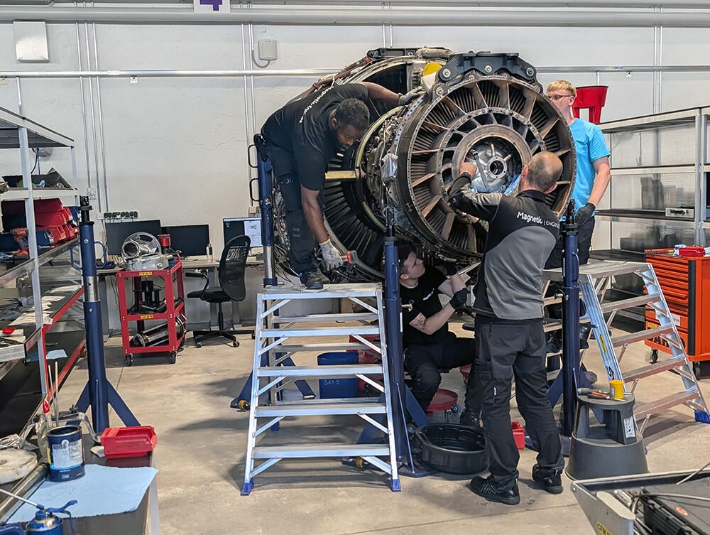 Technicians working on engine
