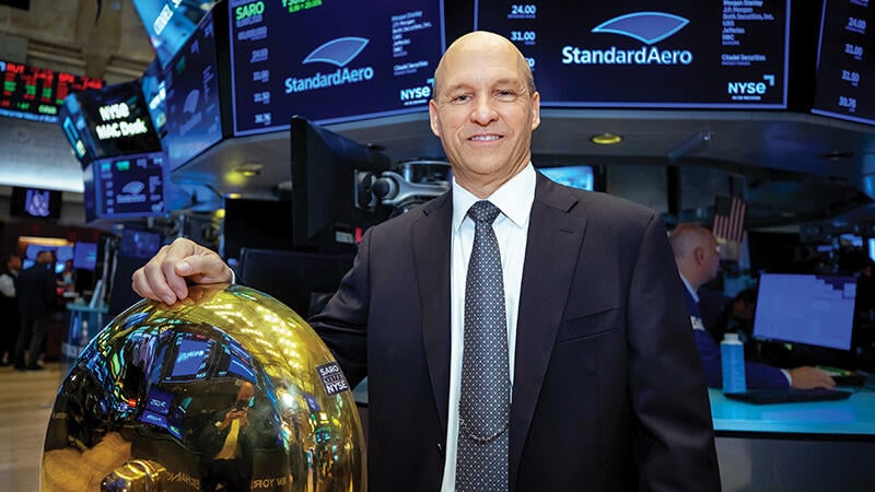 Russell Ford posing by the NYSE bell