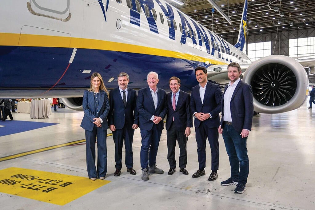 six people standing in front of Ryanair aircraft