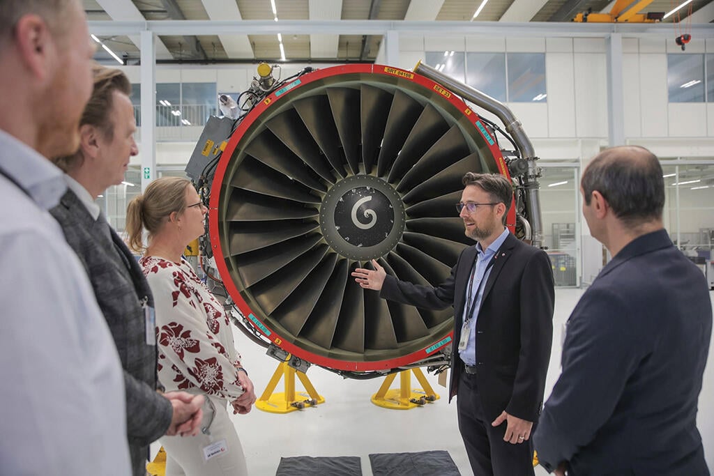 people standing in front of aircraft engine