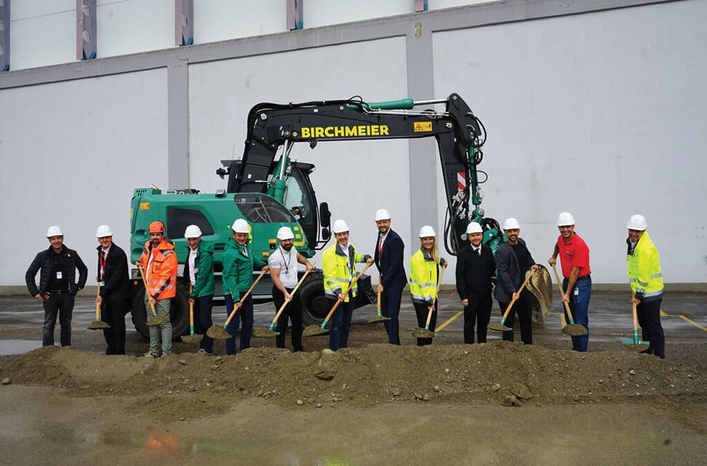 group of people holding shovels for groundbreaking