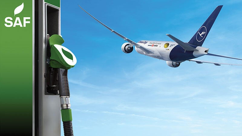concept art of aircraft flying in background with sustainable aviation fuel pump in foreground
