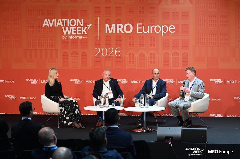 panelists and moderator onstage at mro europe