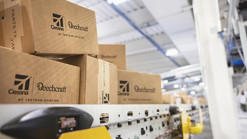 shipping boxes moving through a Textron Aviation automated conveyor facility