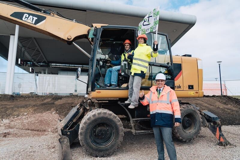 sofia airport representatives pose with an excavator 