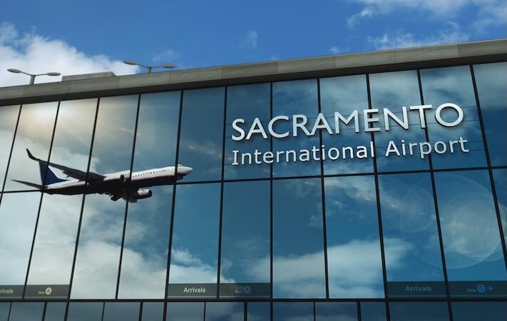 aircraft landing at sacramento international airport mirrored in terminal