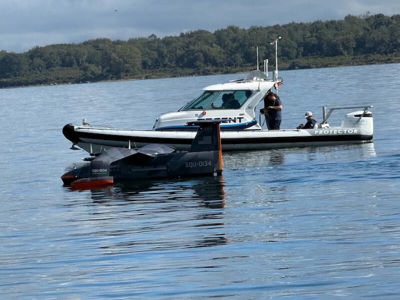squire in water next to protector chase boat