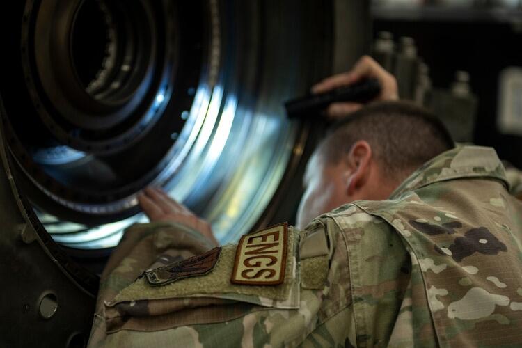 USAF technician examines engine