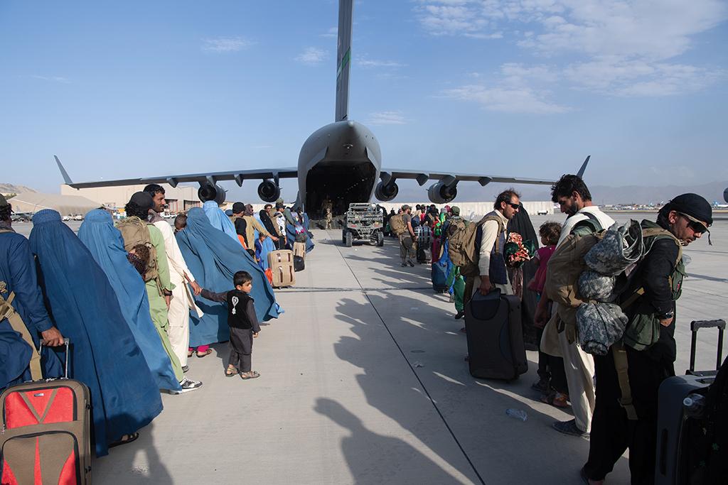 Two columns of civilians line up to board a waiting U.S. Air Force C-17 for evacuation from Kabul.