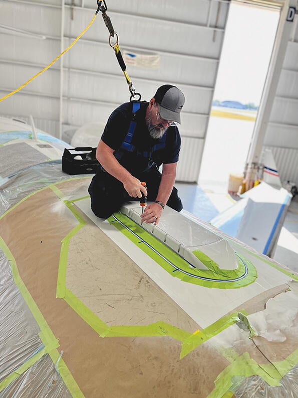 employee installing Gogo Galileo HDX antenna