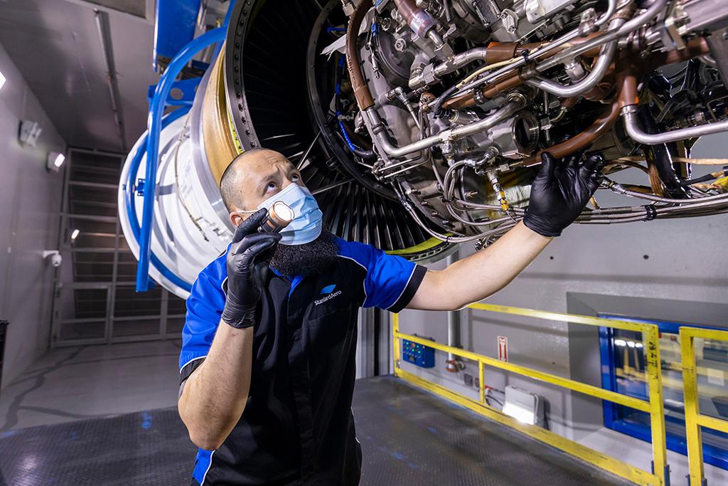mechanic working on aircraft engine