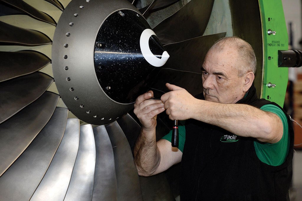 aircraft technician working on engine