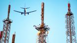 An aircraft overflies a 5G tower