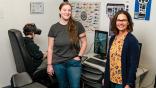 Embry-Riddle researcher and students with helicopter simulator