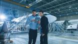 aerospace industry executives in aircraft hangar