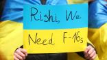 A fan of Ukraine holding a ukraine flag with a message on saying Rishi we need f-16s during the UEFA EURO 2024 qualifying round group C match between England and Ukraine