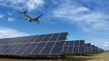 Aircraft flying over solar panels