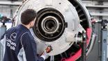 Technician performing engine maintenance