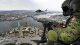 Canadian Air Force pilot in CH-146 Griffon helicopter flies over Parliament Hill