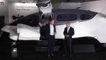 German Chancellor Olaf Scholz (R) listens to Lilium Air Mobility CEO Klaus Roewe as they next to a Lilium Jet