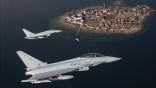 two Eurofighter jets flying over island