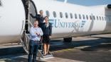 simon cook in front of universal air plane on tarmac