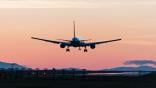 jet flying into sunset