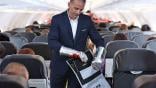 flight attendant using fire containment bag