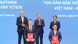 Vietjet CEO Dinh Viet Phuong and Qazaq Air CEO Adilbek Umraliyev exchange the cooperation agreement, witnessed by Vietnam General Secretary To Lam, Kazakhstan Deputy Prime Minister Yermek Kosherbayev, and Vietnam Deputy Prime Minister-Foreign Minister Bui Thanh Son