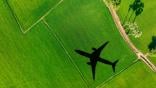 airplane flying over green land