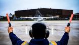 An Air Force technician marshals a Cessna 172 at Joint Base McGuire-Dix-Lakehurst, N.J., in April 2024