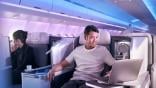 Man working on laptop in A330neo Airspace business class