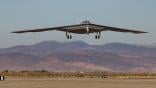 B-21 flying just above ground