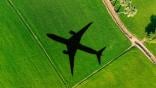 Plane shadow on green field