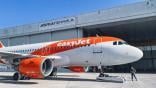 An easyjet aircraft in front of an Adria Tehnika aircraft maintenance hangar