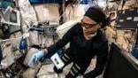 NASA astronaut Jeanette Epps configures the Metal 3D Printer to produce experimental samples from stainless steel. NASA