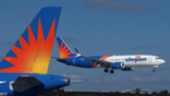 Allegiant Airlines aircraft parked and inflight