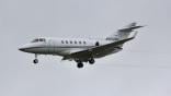A Hawker 900XP descends to land.