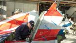 NTSB inspector studying aircraft wreckage