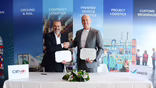 CEVA Logistics APAC leader Olivier Boccara (left) and HAECO general manager group procurement Christian Pinter stand in front of a white-clothed table after having signed an air freight contract.