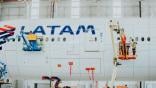 Lufthansa Technik employees work on a LATAM aircraft