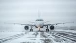 snow on an airplane and on runway