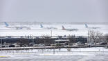united and american aircraft lined up to take off snowy day chicago o'hare airport