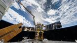 The Japanese HTV-X1 cargo spacecraft is pictured attached to the Earth-facing port on the International Space Station’s Harmony module with the Canadarm2 robotic arm in the foreground. NASA