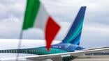 alaska airlines tail fin with italian flag in the foreground