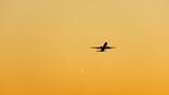 Generic aircraft inflight in yellow sunset sky